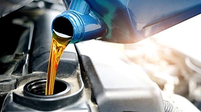 Fresh oil being poured into a vehicle's engine.