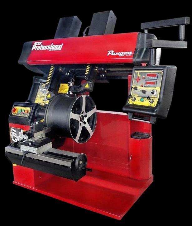 A professional tyre-fitting and balancing machine holding an alloy wheel.