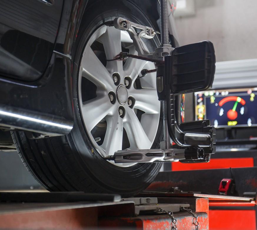 Wheel alignment sensors clamped to a car's wheel.